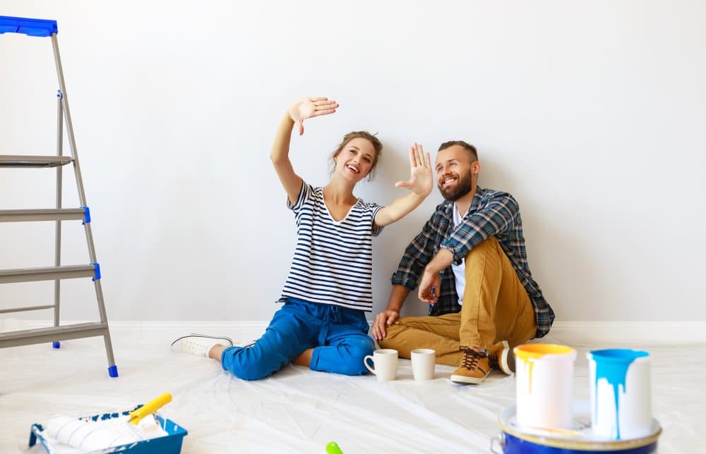 young happy family married couple dreams of renovating house and planning a design project