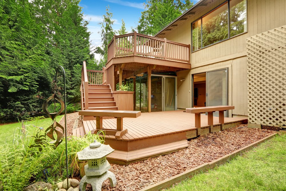 House with walkout deck and patio. Backyard view